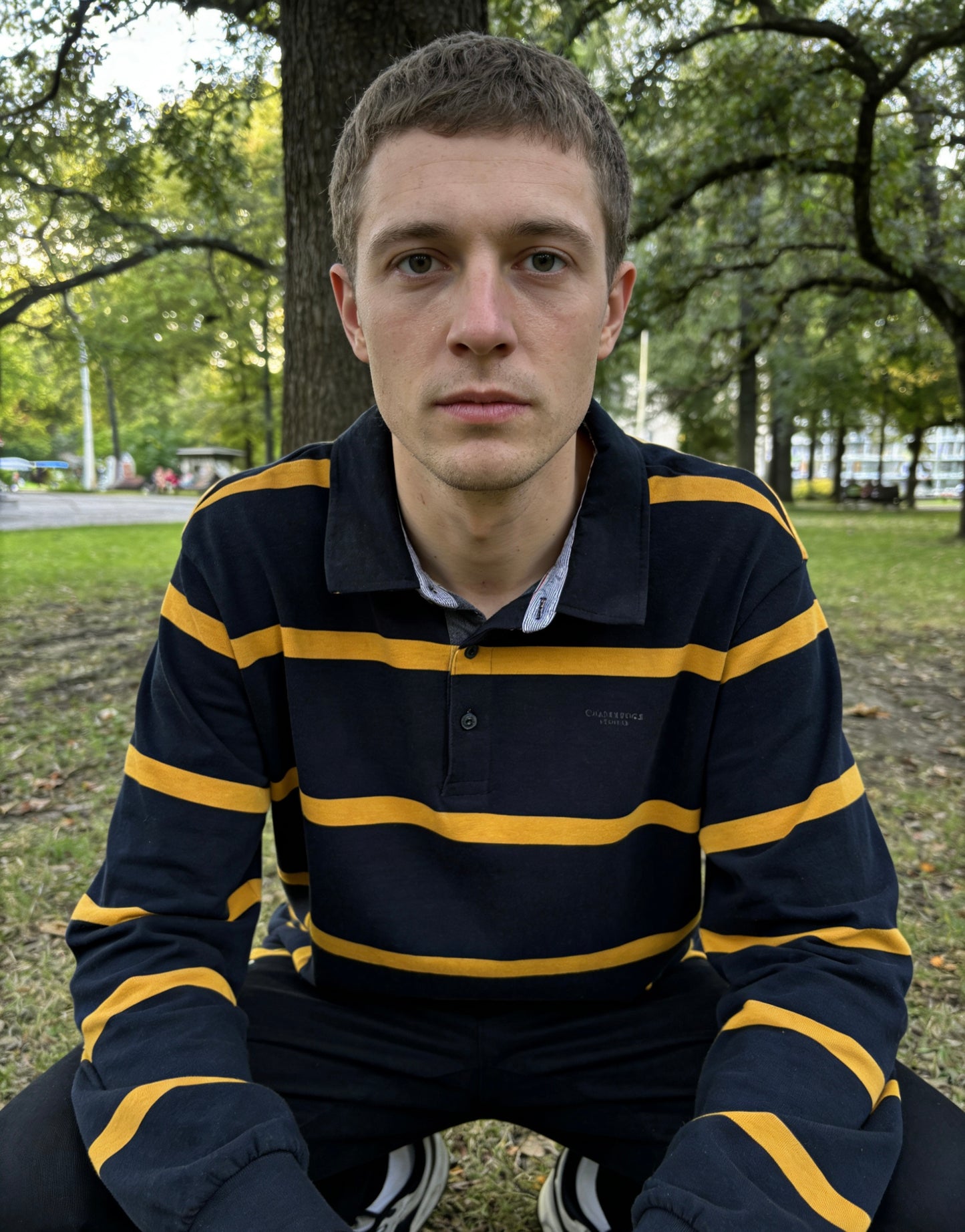 Man’s navy blue and gold striped long-sleeve rugby shirt